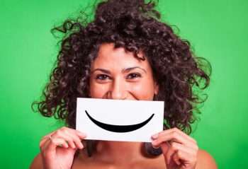 woman holding smiley card