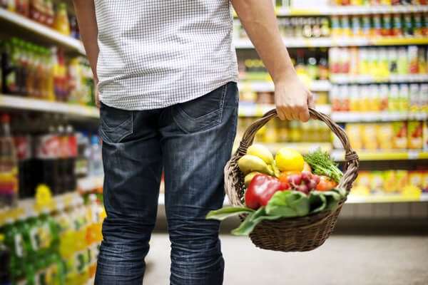man holding shopping basket with healthy food